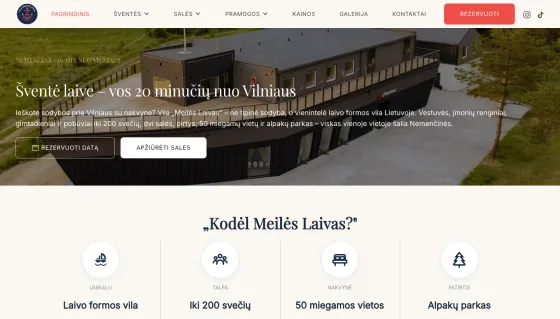 Vila Meilės Laivas website hero with an aerial view of the boat-shaped villa
